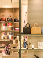 Chic boutique with a variety of handbags and shoes elegantly displayed on shelves.